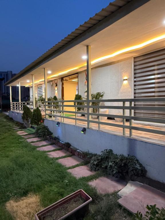 a house with a fence on the side of it at oliv Faram house in Greater Noida
