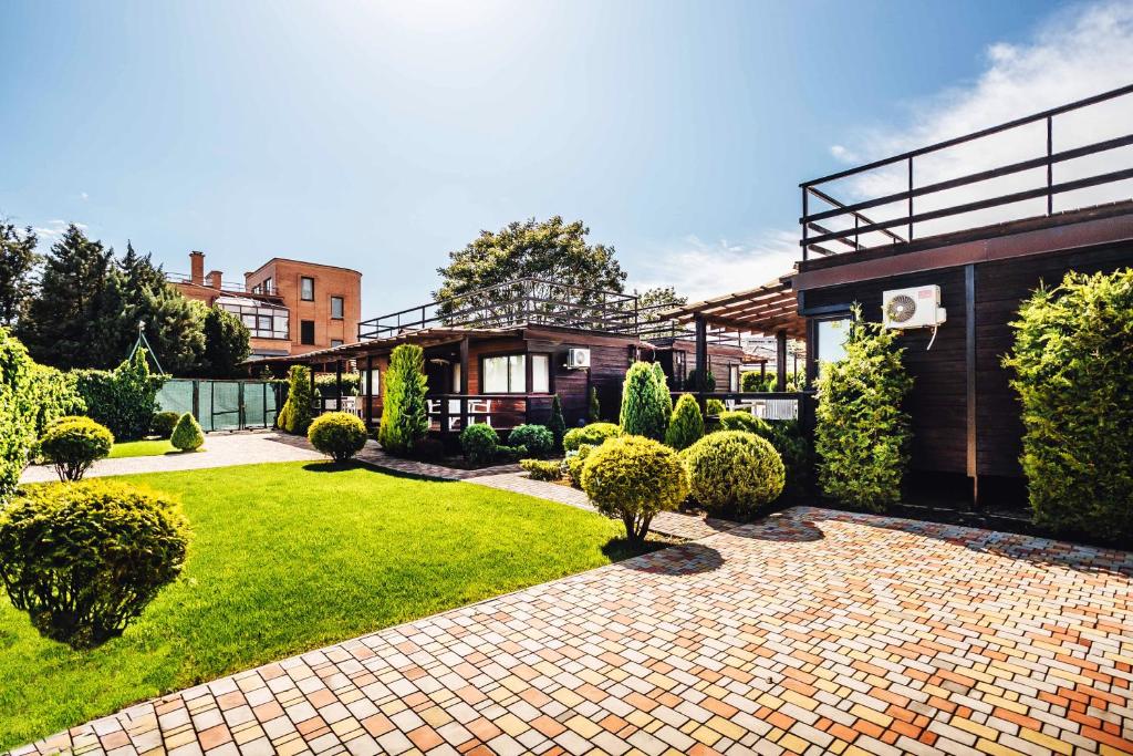 a house with a brick driveway and a lawn at GreenHotel in Chornomorsk