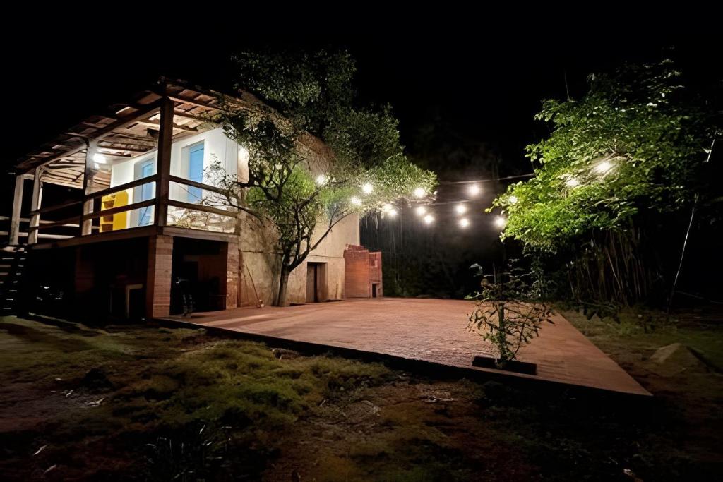 a house at night with lights on it at Piccola Cucina: Casa centenária Vale dos Vinhedos in Garibaldi