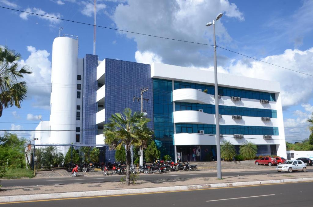 a building with motorcycles parked in front of it at Hotel Alecrim in Caxias das Aldeias Altas