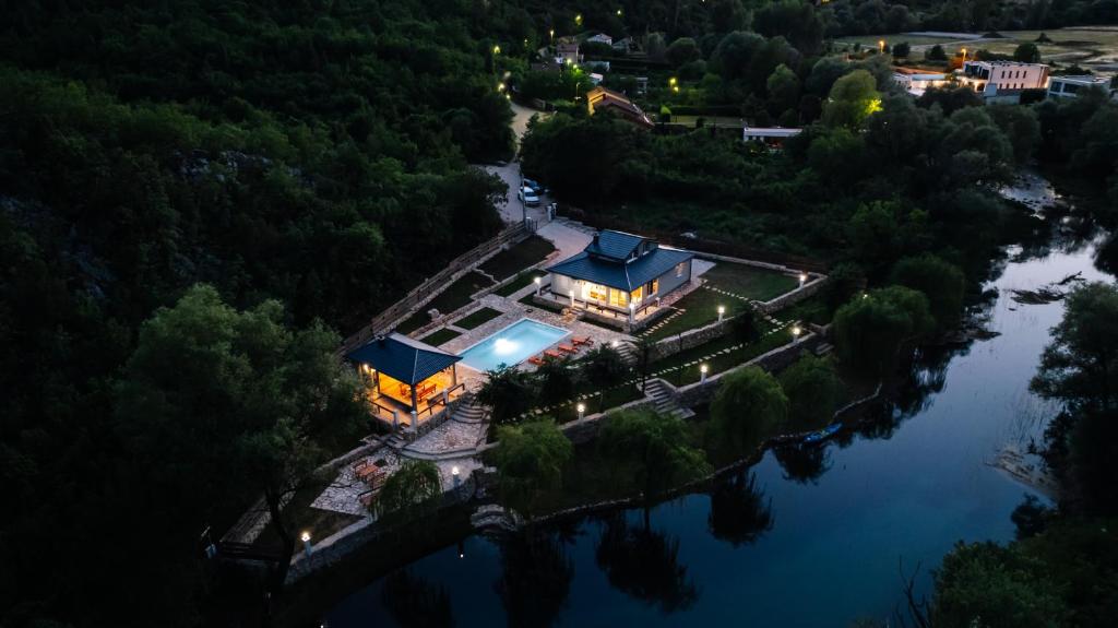 an aerial view of a house on a river at Villa Vrelo Oasis in Malo Polje