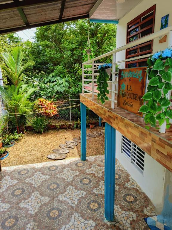 a patio with a table with a book shelf at La Orquídea Cabañas in Playa Ladrilleros