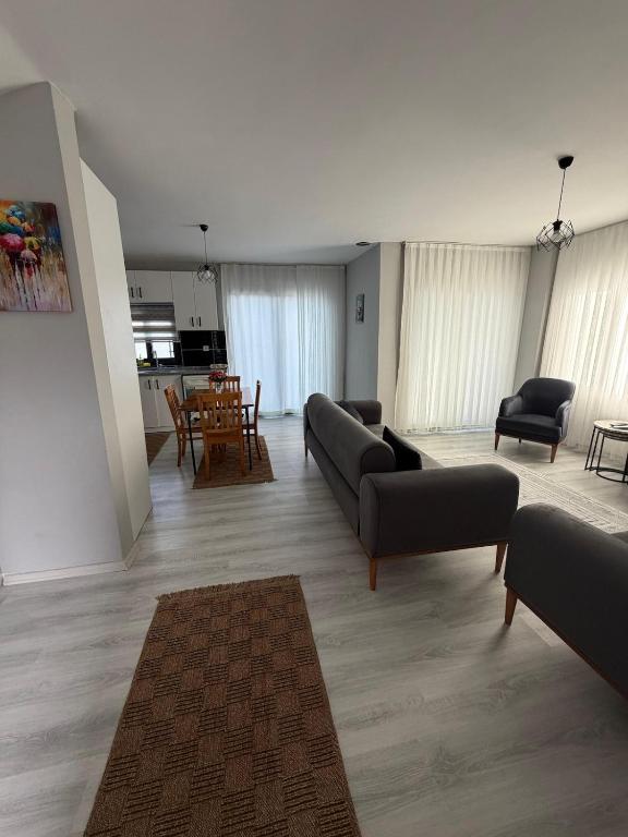 a living room with couches and chairs and a table at Duplex Villa with Private Pool in Akyaka Ataköy in Muğla