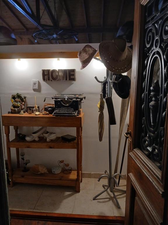 a room with a hat and a shelf with shoes at El Camino in Gardey