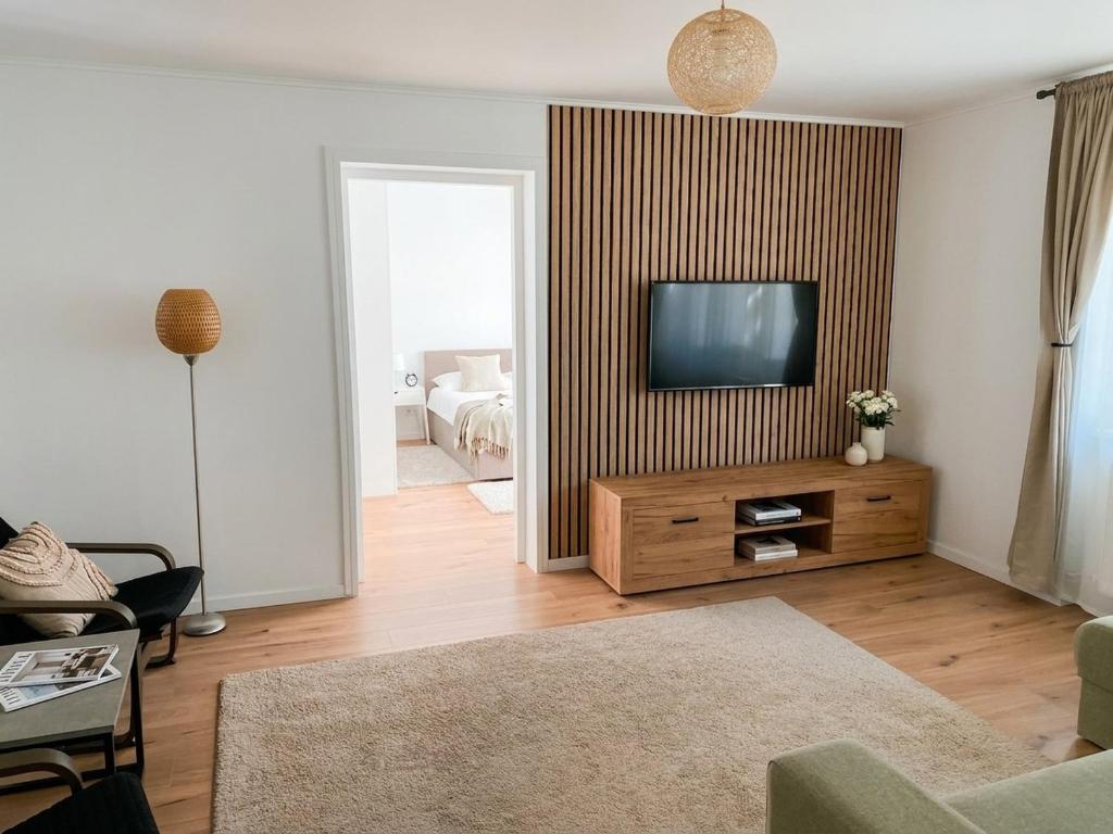 a living room with a flat screen tv on a wall at Marc Apartament in Turda
