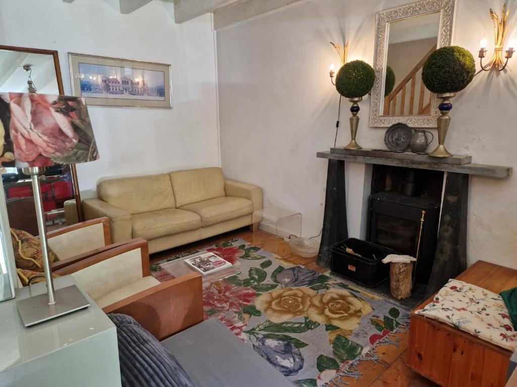 a living room with a couch and a fireplace at Gites Armorique in Plésidy