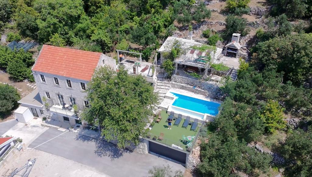 an overhead view of a large house with a pool at Villa Jerković-Secluded house and apartment with pool in Drašnice