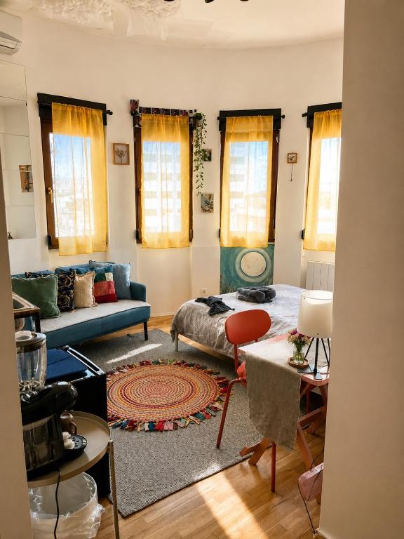 a living room with a couch and a table at Central Artsy Studio, self check-in! in Bucharest