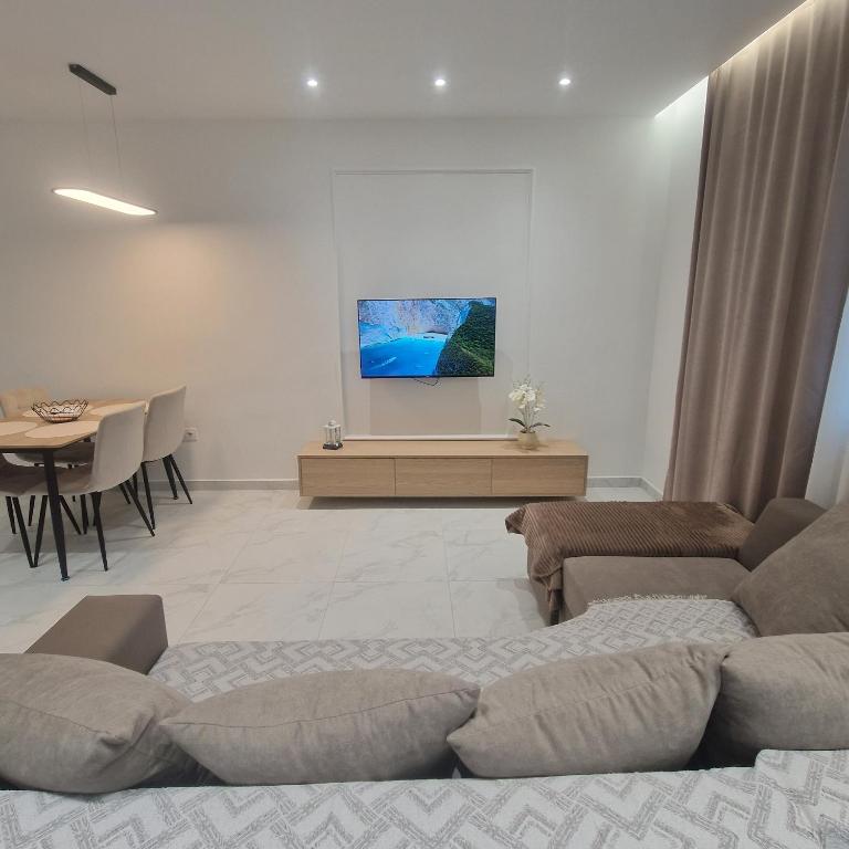 a living room with a couch and a table at Joel Family Apartment's Golem Center in Golem