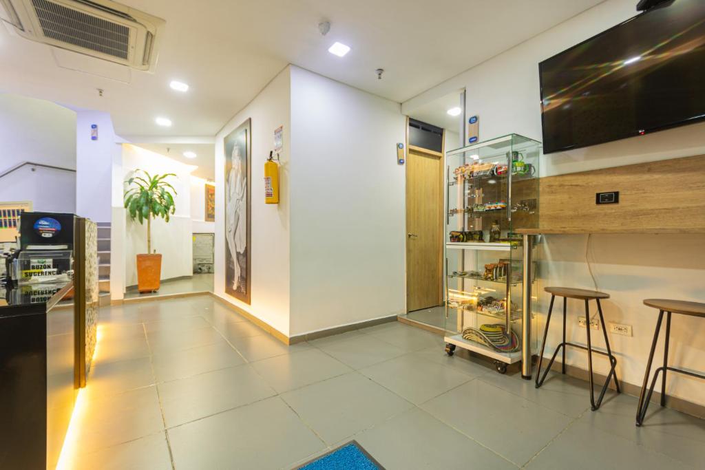 a room with a counter and two stools in it at Hotel Zona Express San Diego in Medellín