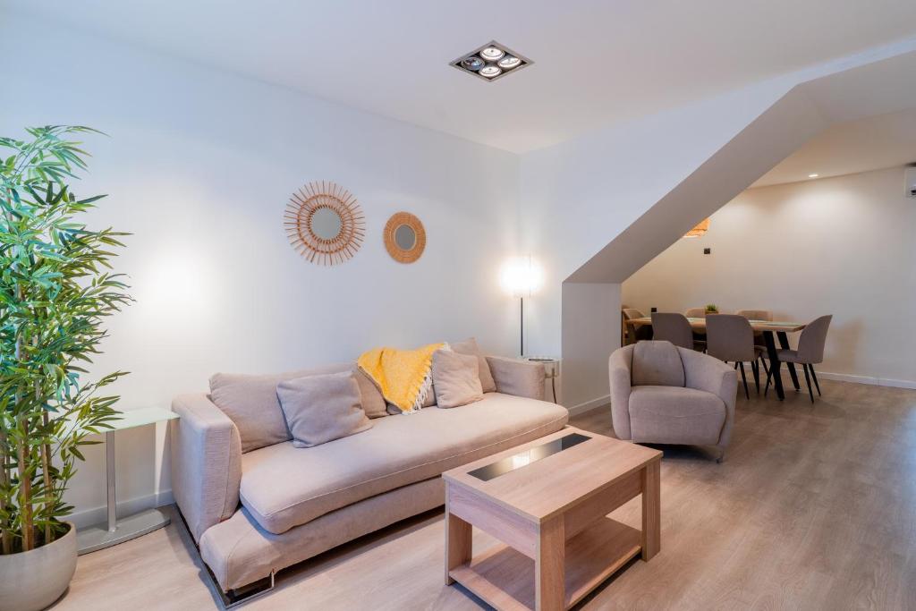 a living room with a couch and a table at Elcano Living 6 in Grao de Castellón