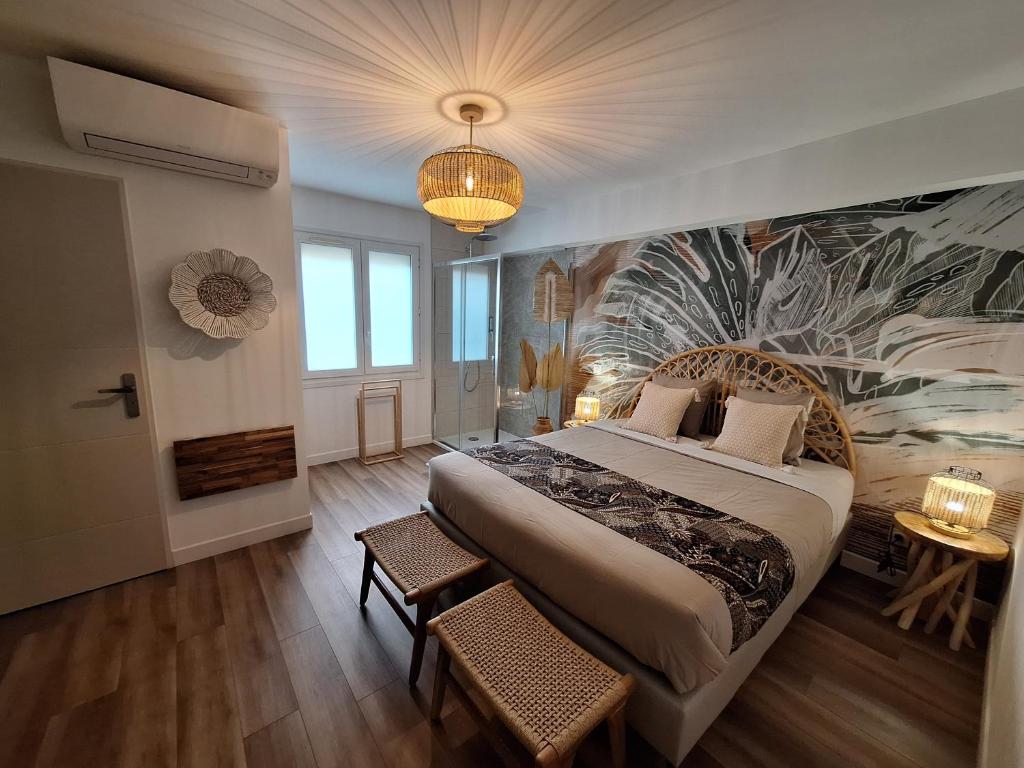 a bedroom with a large bed and a painting on the wall at Villa Pesona in Vias
