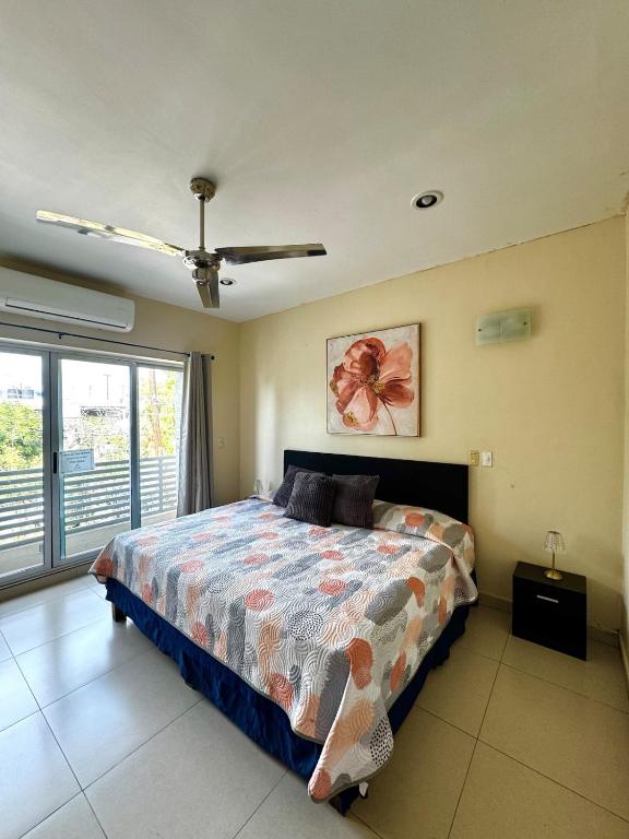a bedroom with a bed and a large window at Estudio #2 a 5 min del malecon in La Paz