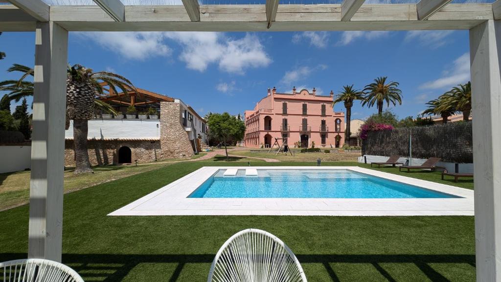 a view from the patio of a villa with a swimming pool at Villa de Lujo Cerca de Sitges in Sant Pere de Ribes