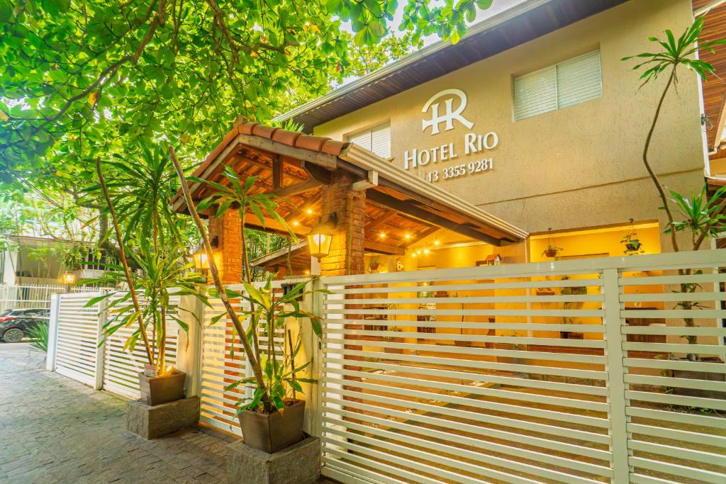 a building with a fence in front of it at Hotel Rio Guarujá - "Sua casa na praia" in Guarujá