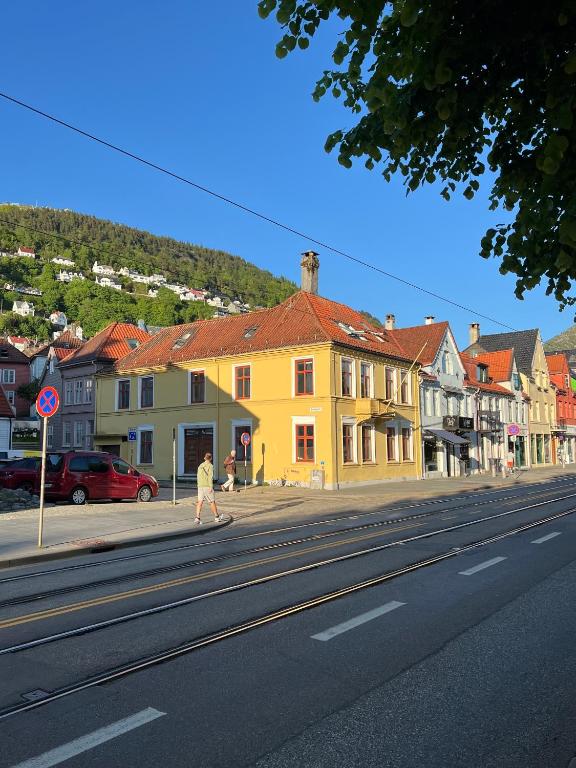 a person riding a skateboard down a city street at Bergen City hostel Rooms in Bergen