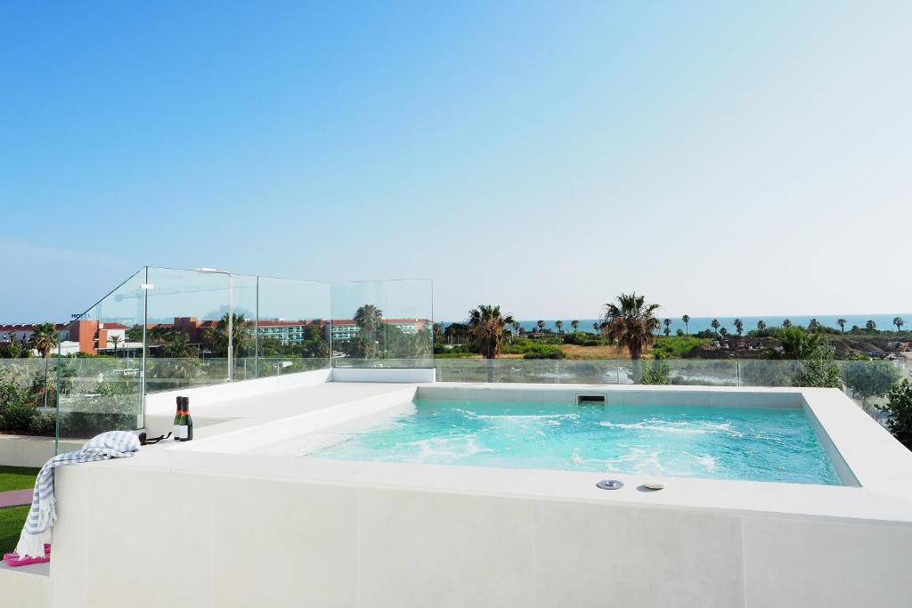 a swimming pool on the roof of a house at Penthouse duplex with jacuzzi, 5 min to beach in Chipiona