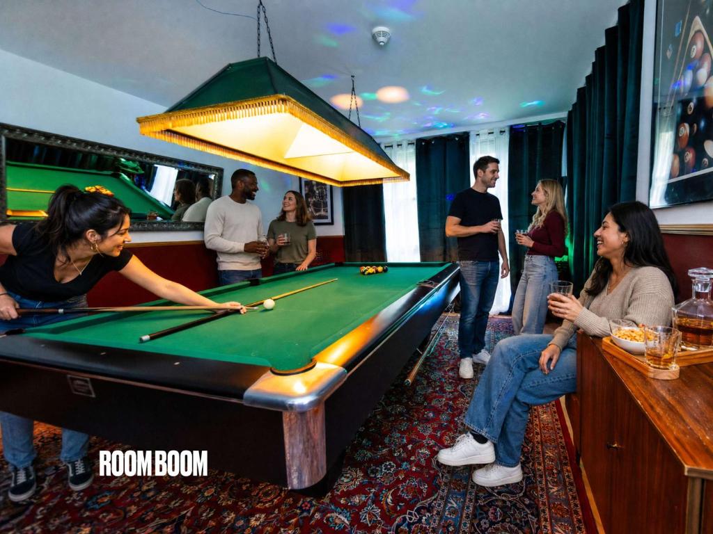 a group of people standing around a pool table at Rheinsteig Chalét Bendorf in Bendorf
