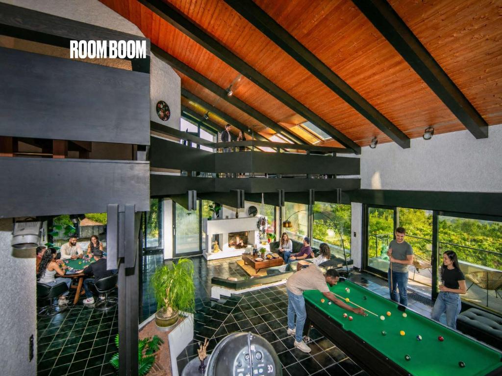 a pool table in a room with people playing pool at Villa Panoramica Pool & Sauna in Weitersburg