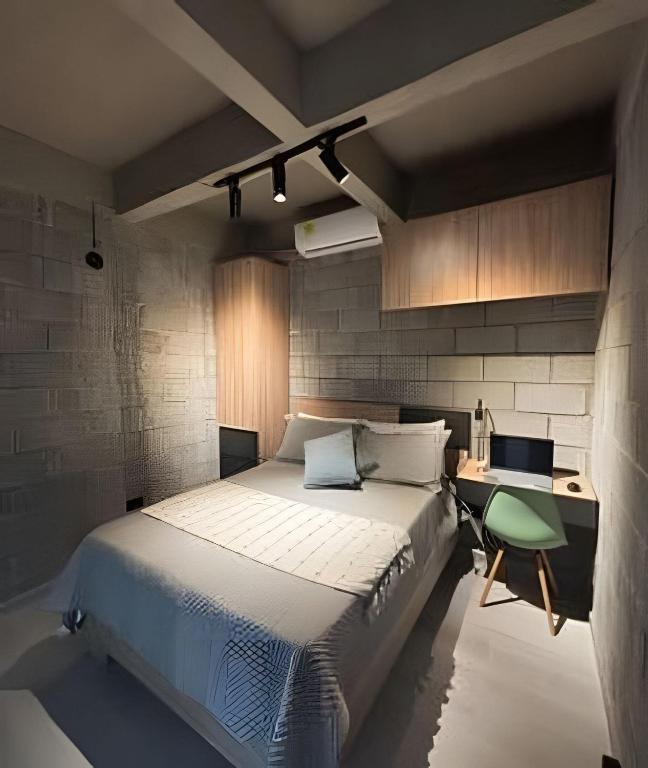 a bedroom with a large bed and a desk at Our Home Granada in Cali
