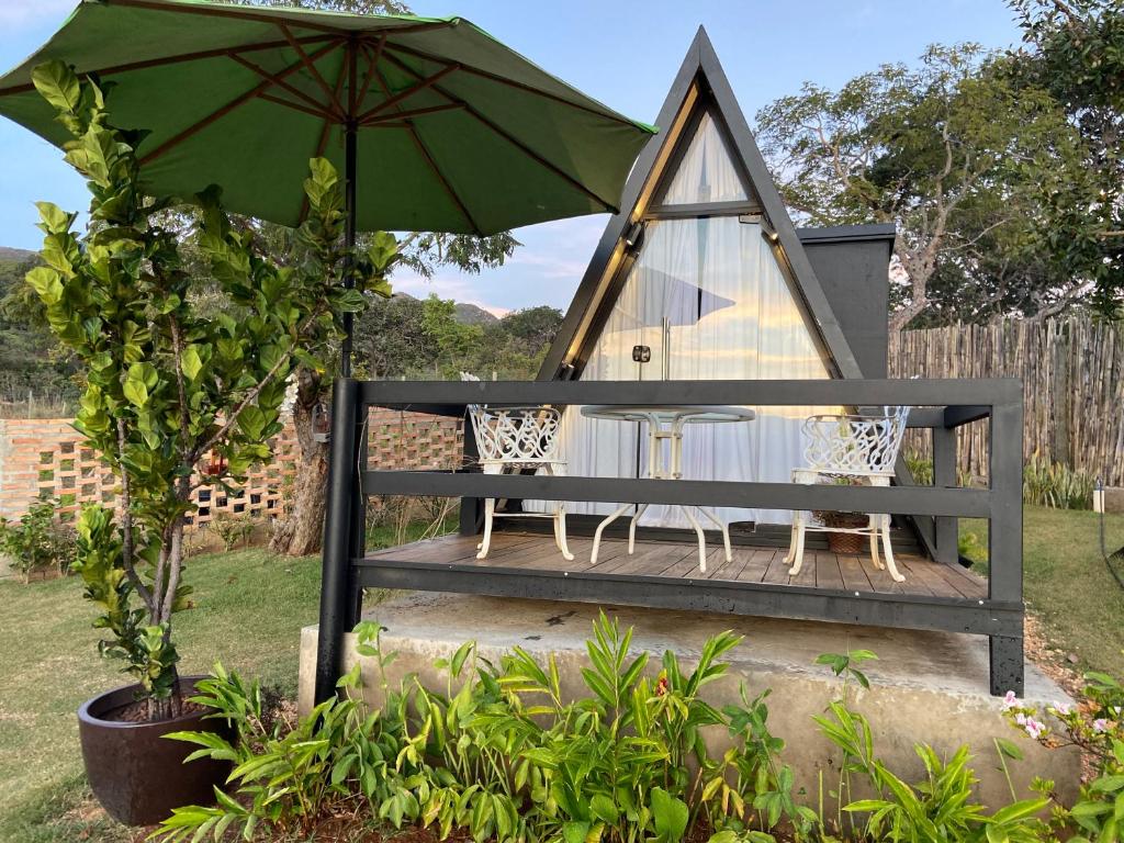a gazebo with a table and an umbrella at Mini Cabana in Serra do Cipo