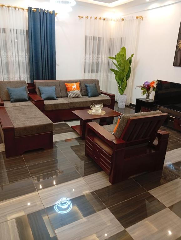 a living room with couches and a piano at Résidence Prestige KGV Appt 304 in Douala