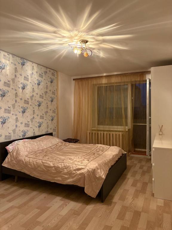 a bedroom with a bed and a ceiling fan at Marsel Odesa in Odesa