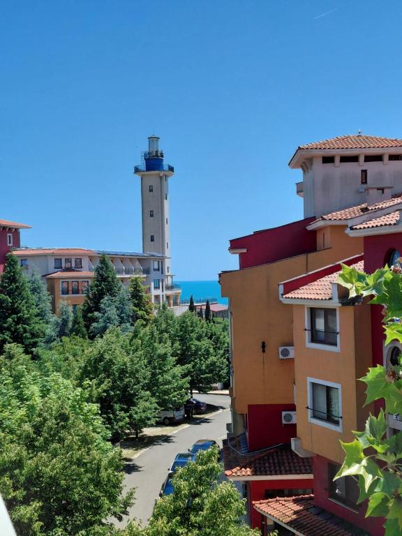 a view of a city with a lighthouse in the background at Studio Marina Cape 89 in Aheloy