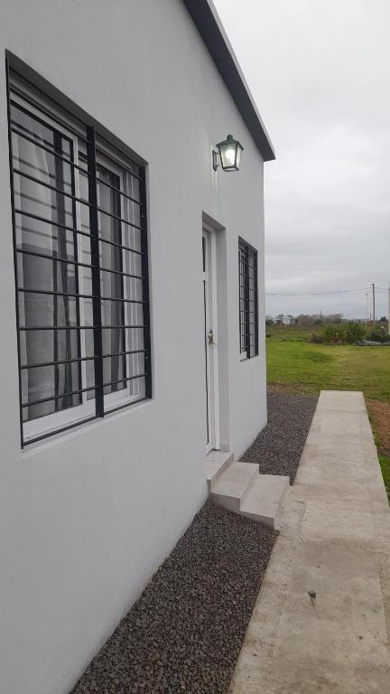 a white building with two windows on the side of it at Brisa de Pueblo in Caseros