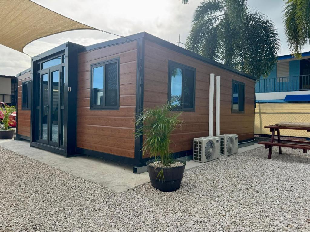 a small cabin with a potted plant in front of it at Babus Villas del Sol in El Combate