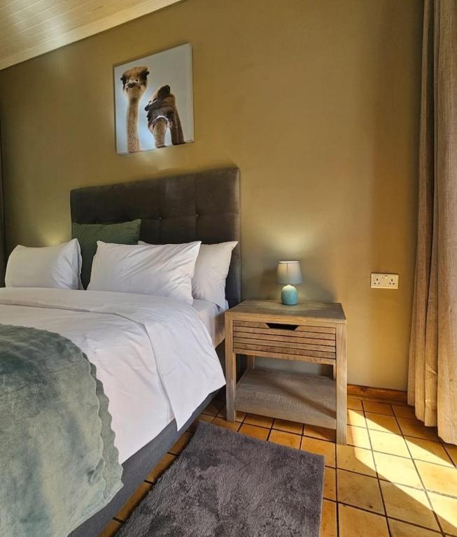 a bedroom with a bed and a side table at Montgomery Highlands Estate in Harare