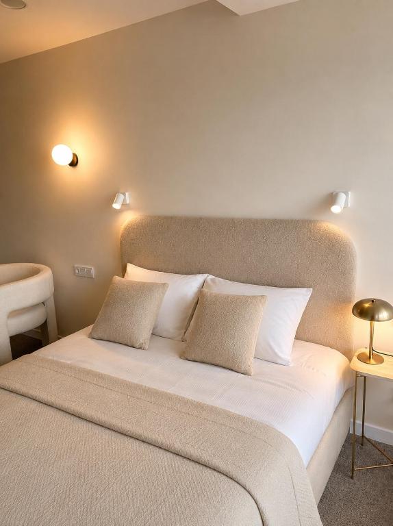 a bedroom with a large bed with two pillows at Apartamentai-studija Palangos kopos in Palanga