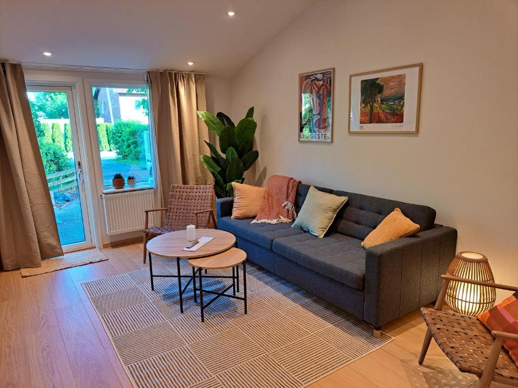 ein Wohnzimmer mit Sofa und Tisch in der Unterkunft Nyrenoverad lägenhet med gratis parkering in Partille