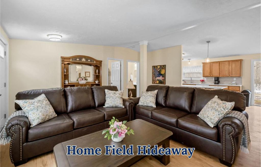 a living room with a brown leather couch at Home Field Hideaway in Pullman
