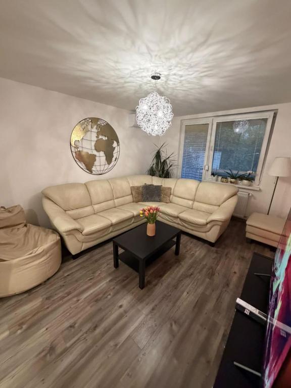 a living room with a couch and a table at Ubytovanie u Tomáša in Nesvady