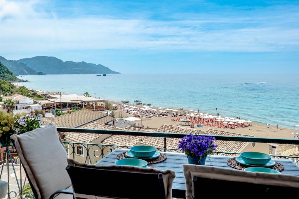 a balcony with a view of a beach and the ocean at Corfu Glyfada Beach Apartments in Glyfada