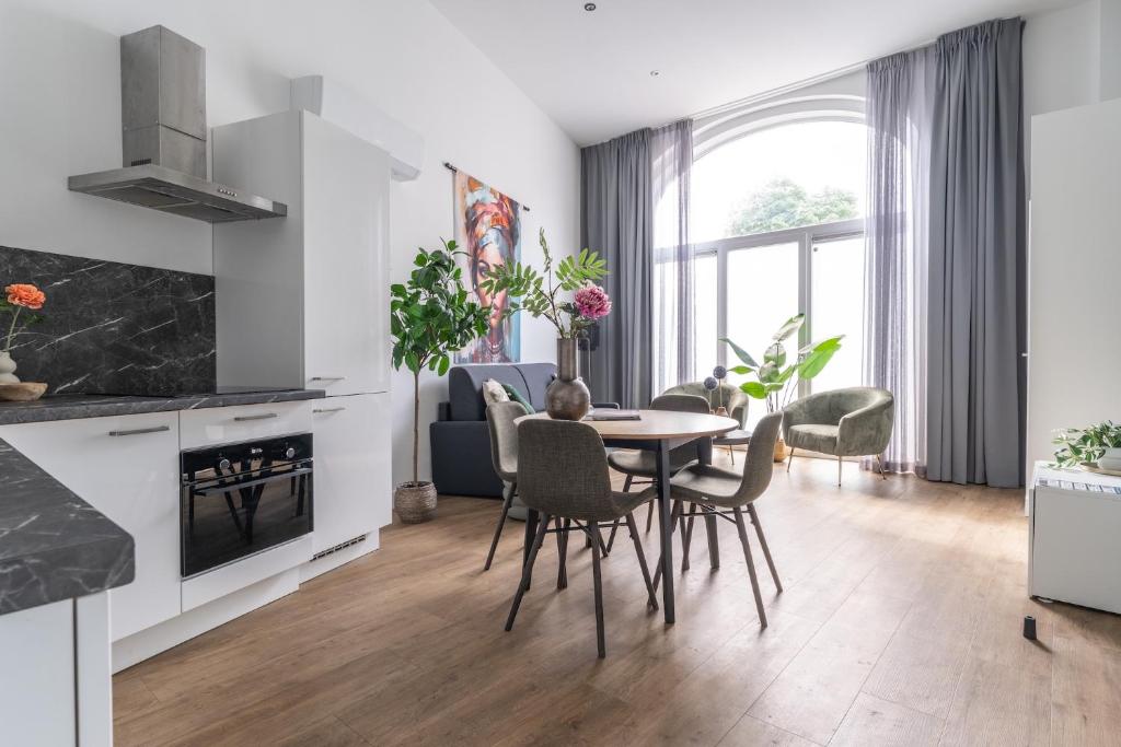 a kitchen and dining room with a table and chairs at Unique home near Tilburg center, uni & Efteling, in Tilburg