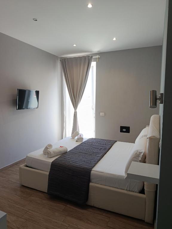 a bedroom with a large bed and a window at B&B Purple Italy in Fiumicino