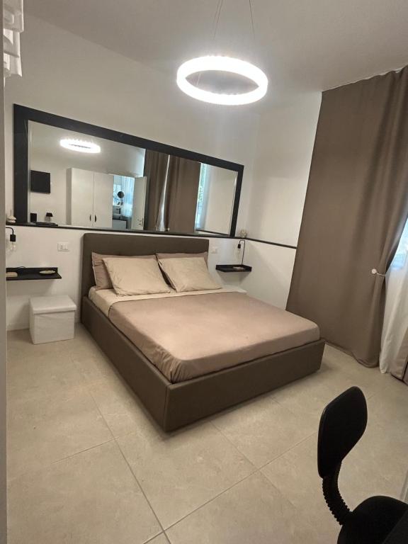 a bedroom with a large bed with a large mirror at Chloè Vacanze in Iesi