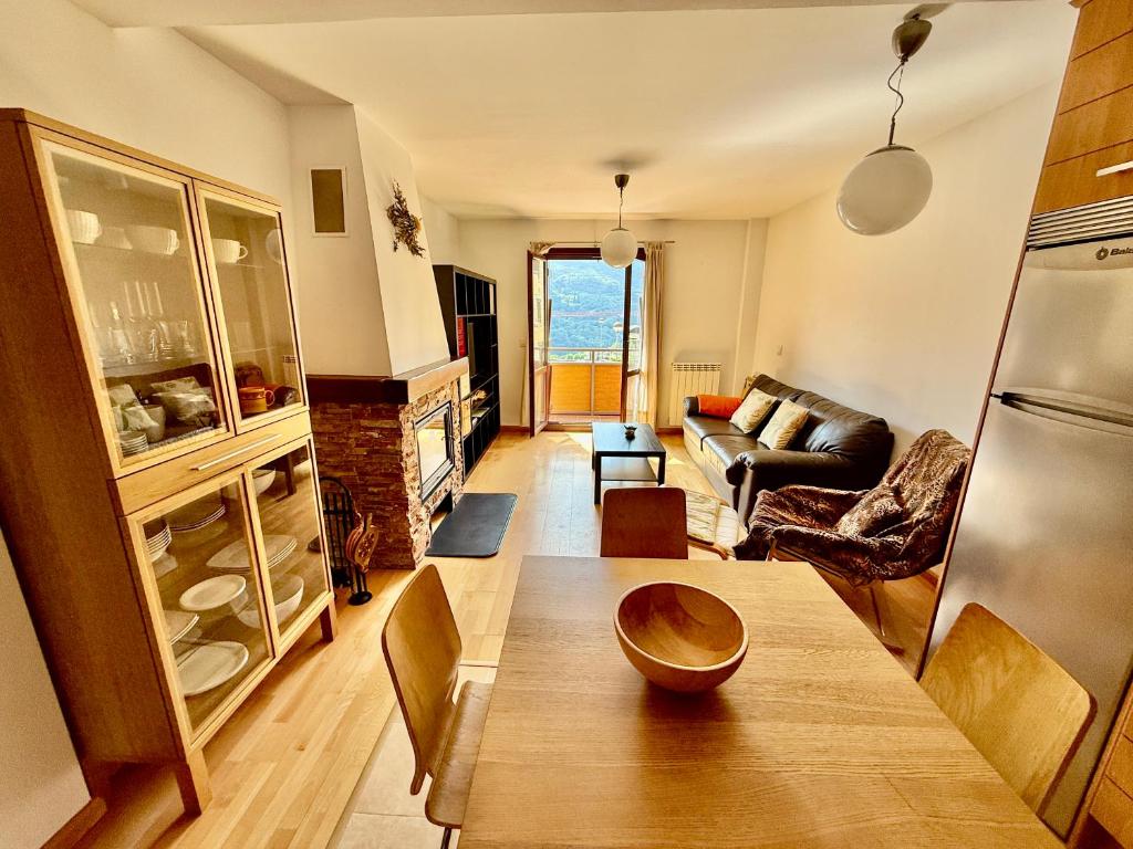 a living room with a table and a couch at Cozy apartment with mountain views in Panticosa