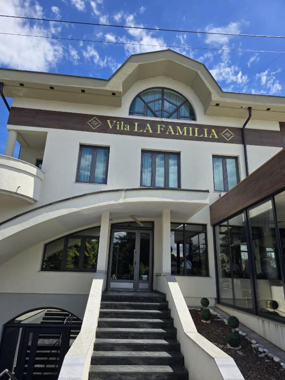 a building with a sign that reads va la familia at Vila La Familia in Budžak