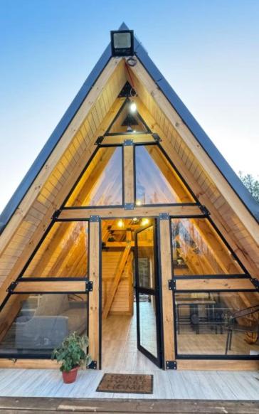 a house with a roof with a glass door at Refugio Alpino in Nacimiento