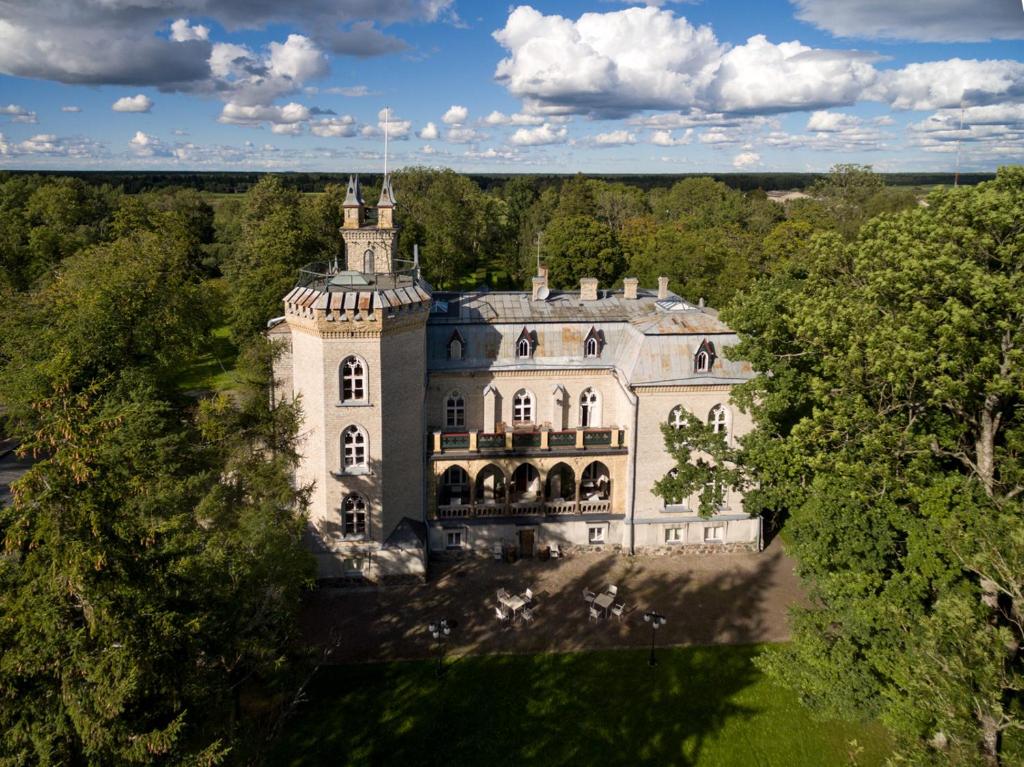 an aerial view of a large house with trees at Laitse Castle B&B in Laitse