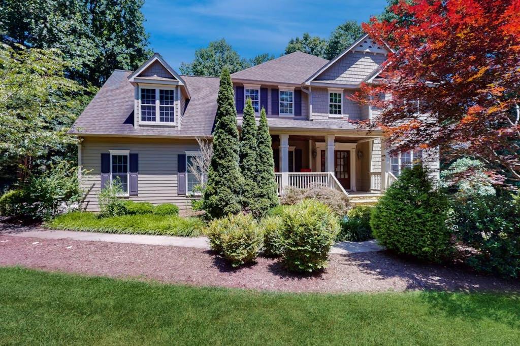 a house with trees and bushes in the yard at The Marlin in Arden