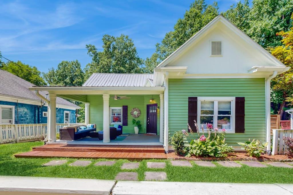 a green house with a porch at The Lime House in Brevard
