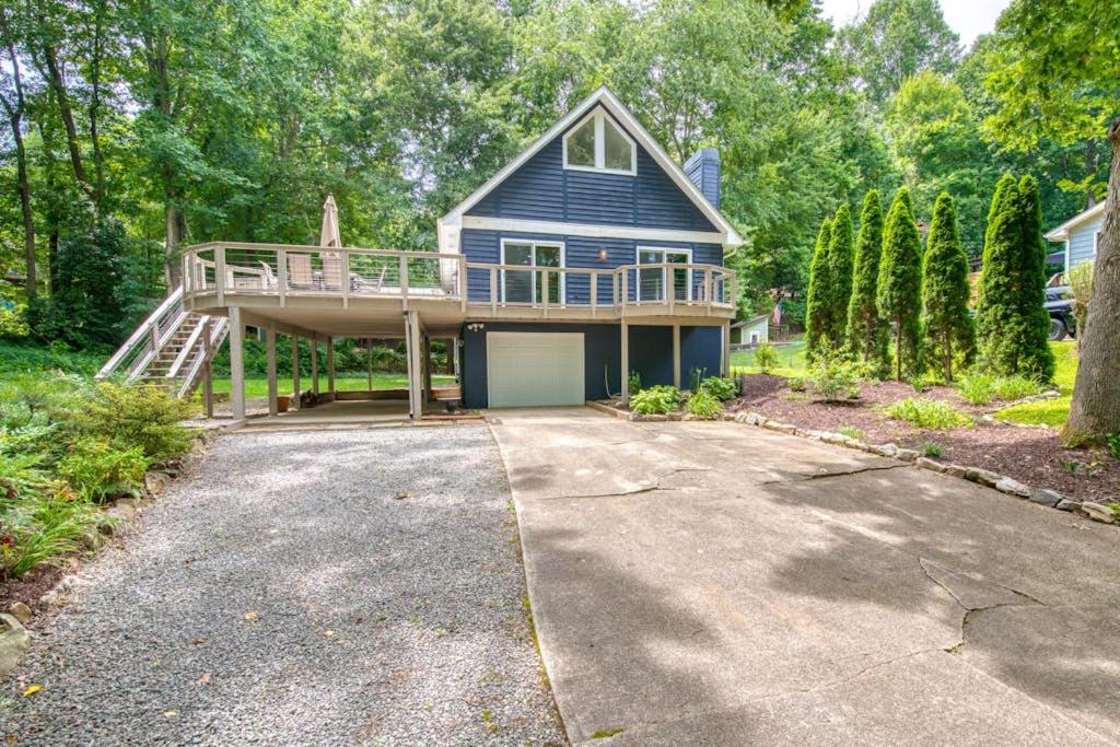 a large blue house with a deck and a garage at Wildwood in Fletcher