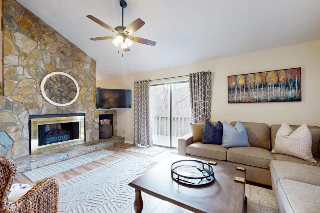 a living room with a couch and a fireplace at Rumbling Bald Resort Unit 2004 in Lake Lure