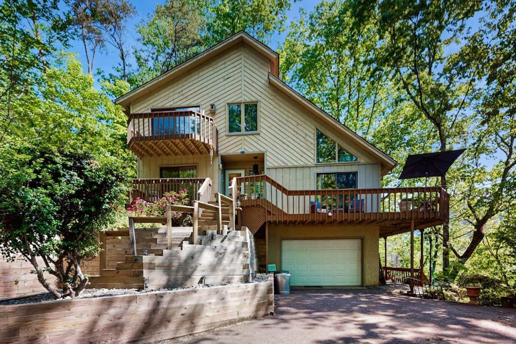 a house with a deck and a garage at Yopp's Treehouse in Lake Lure