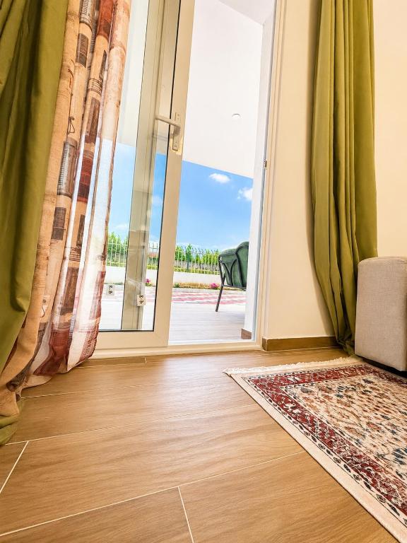 a room with a door open to a patio at Aisha Apartment in Berat