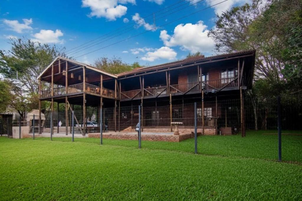 a large building with a roof on top of a field at 56 Crocodile in Komatipoort